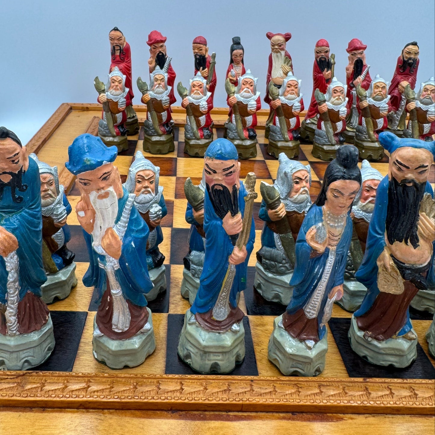 Vintage hand painted ceramic Chinese chess pieces depicting warriors and royalty.