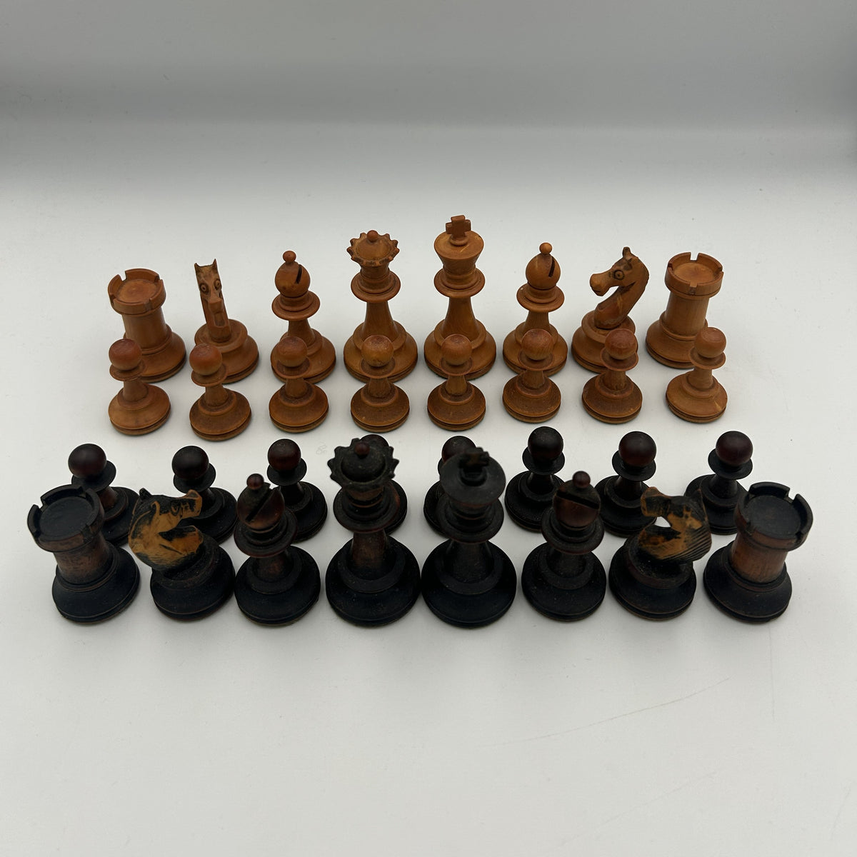 Antique dogfaced knight Staunton style chess pieces in wooden box