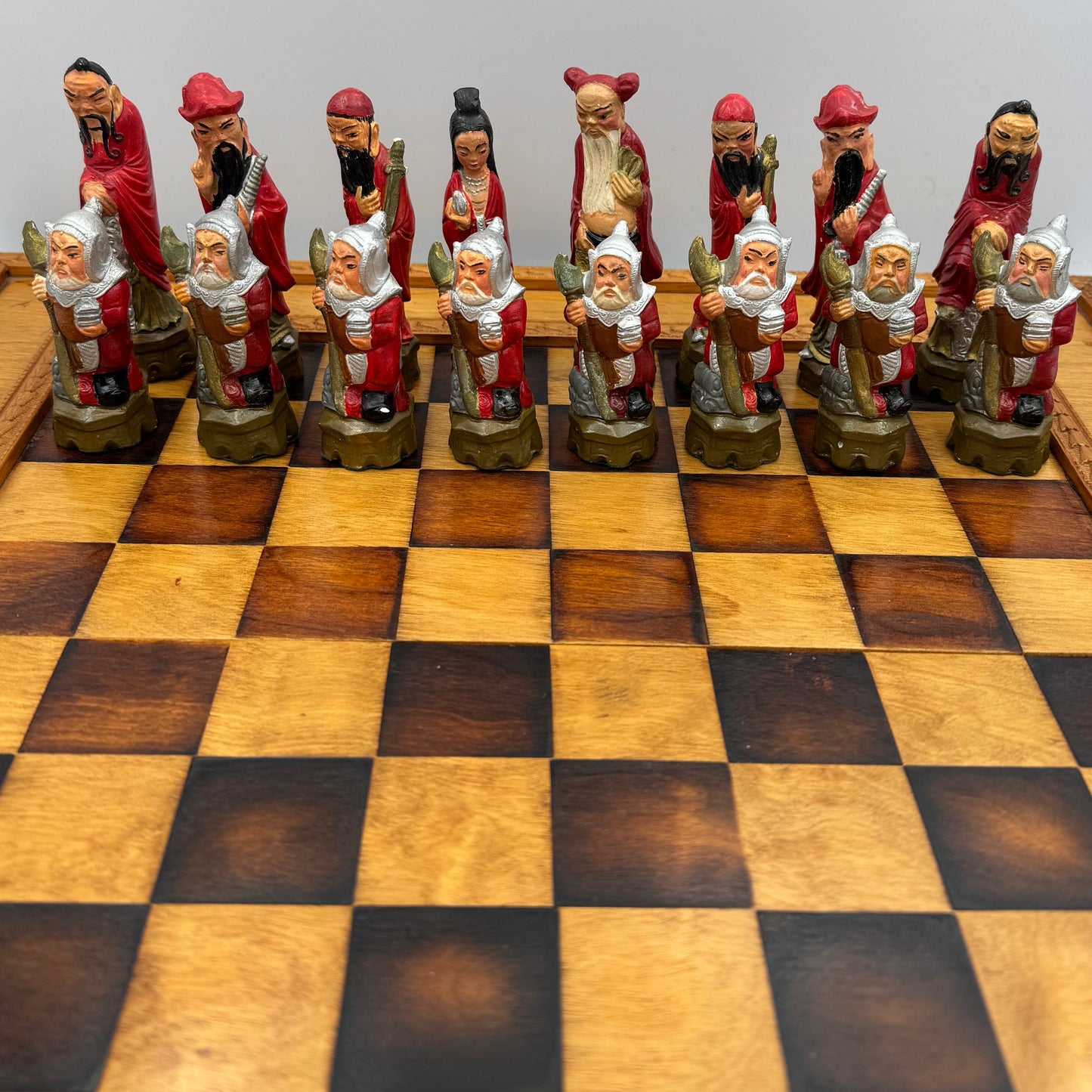 Vintage hand painted ceramic Chinese chess pieces depicting warriors and royalty.