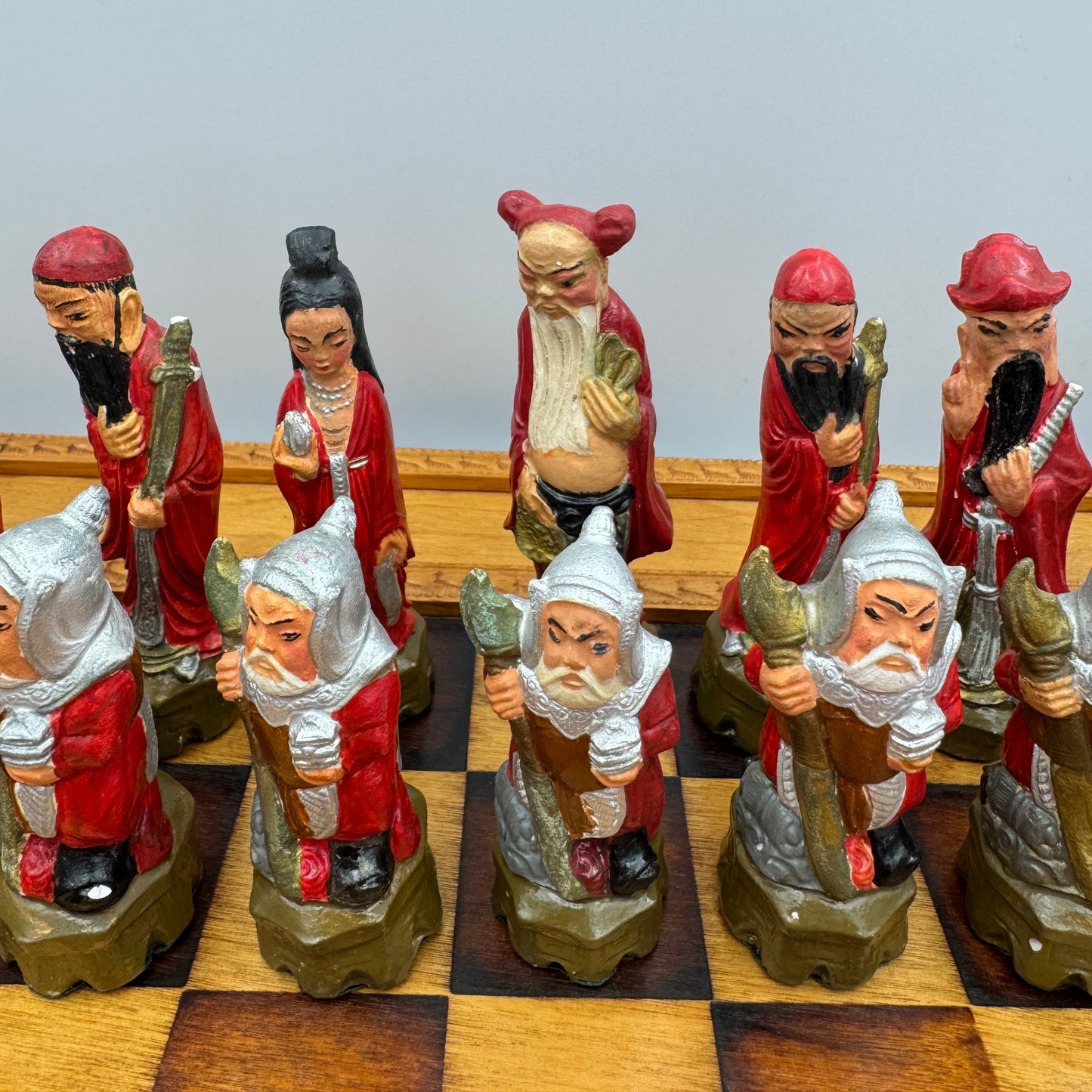 Vintage hand painted ceramic Chinese chess pieces depicting warriors and royalty.