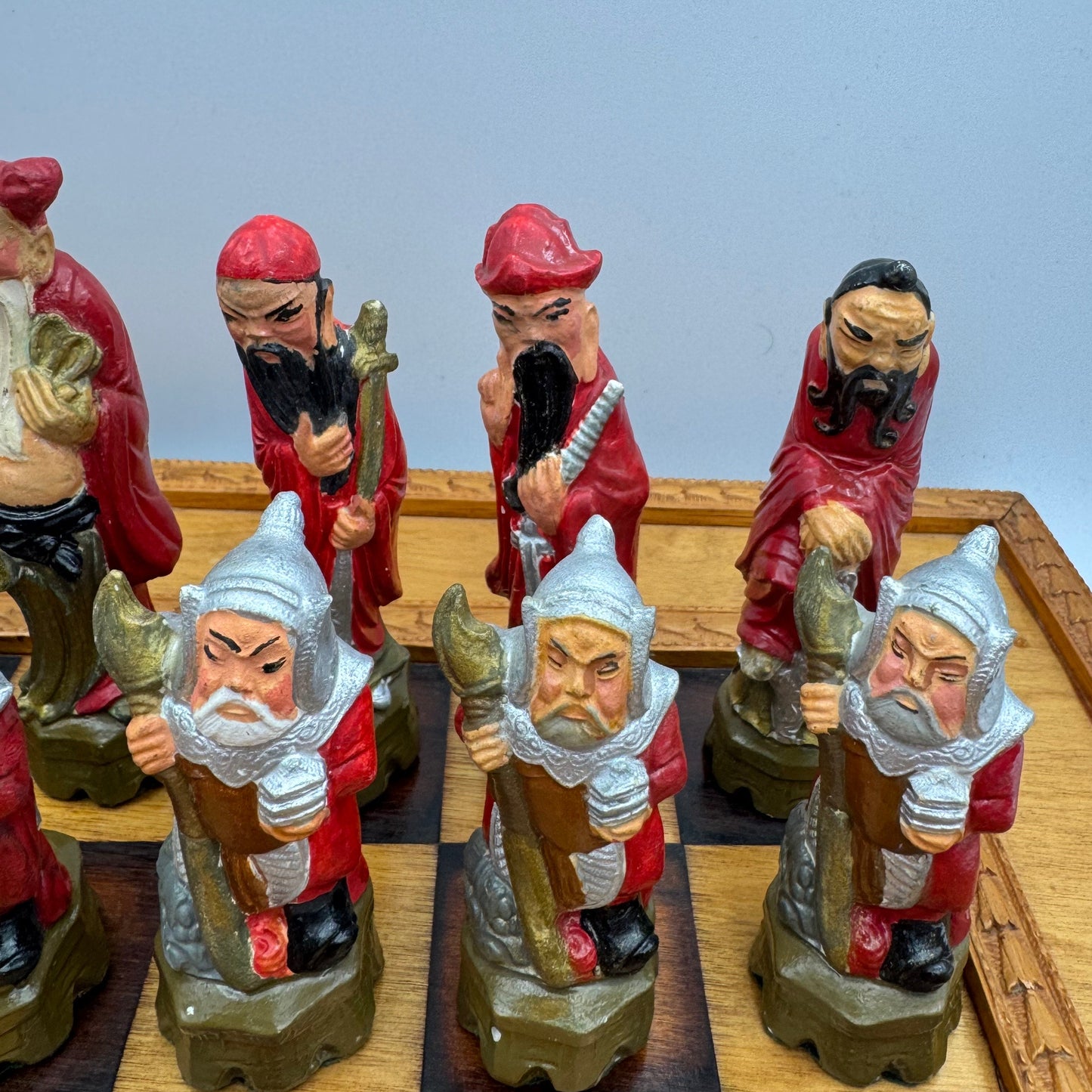 Vintage hand painted ceramic Chinese chess pieces depicting warriors and royalty.