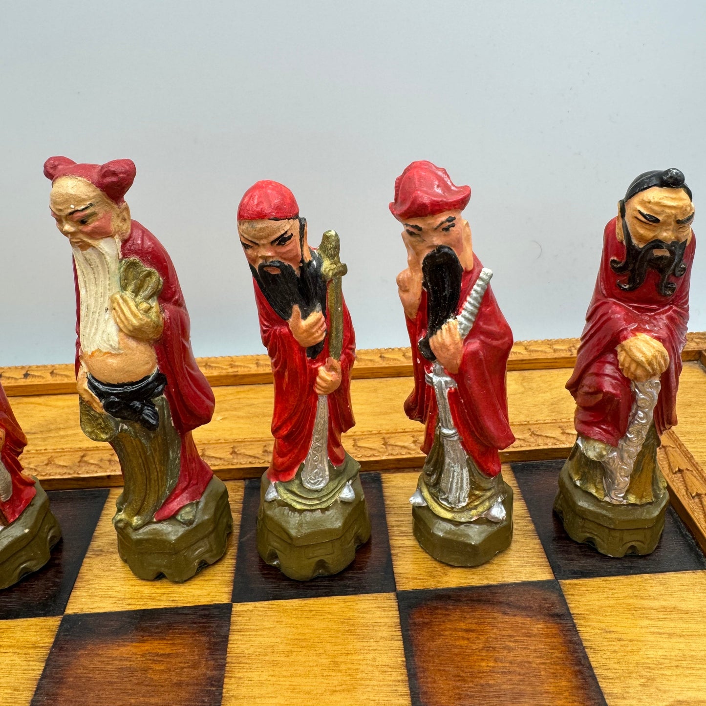 Vintage hand painted ceramic Chinese chess pieces depicting warriors and royalty.
