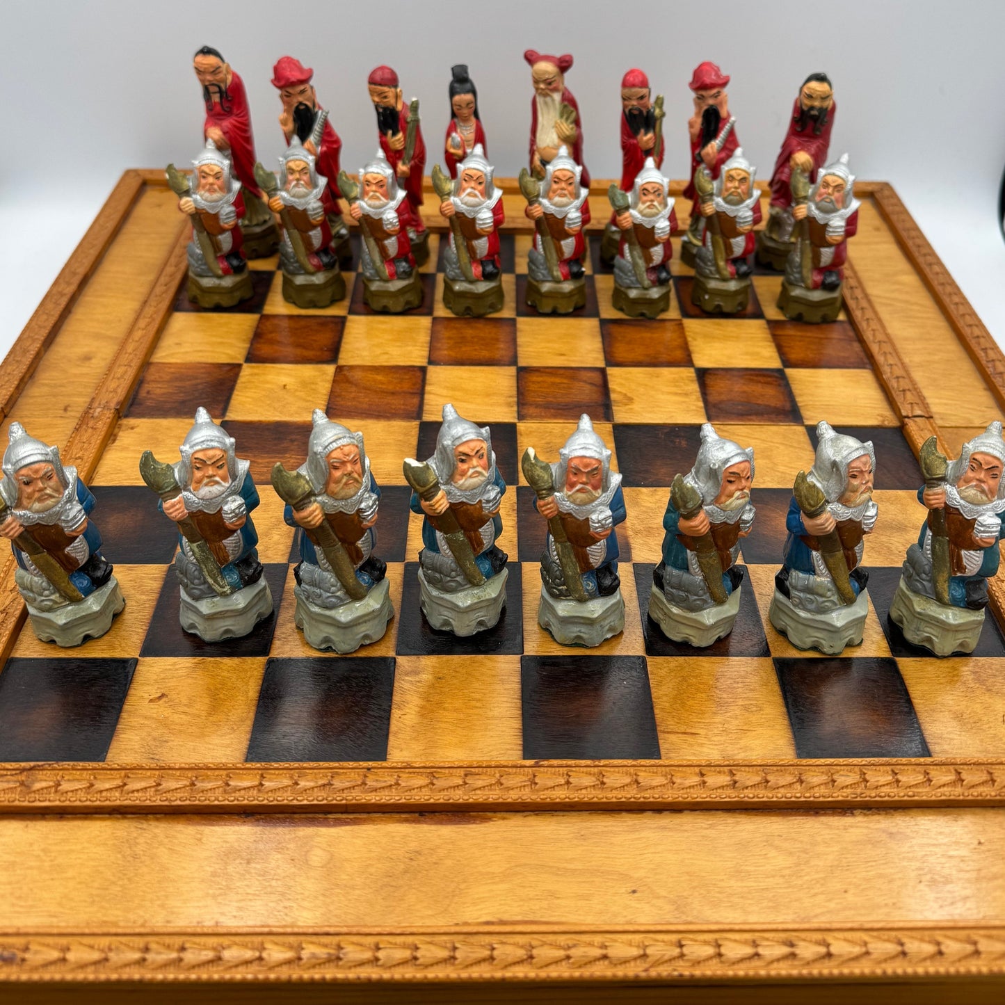 Vintage hand painted ceramic Chinese chess pieces depicting warriors and royalty.