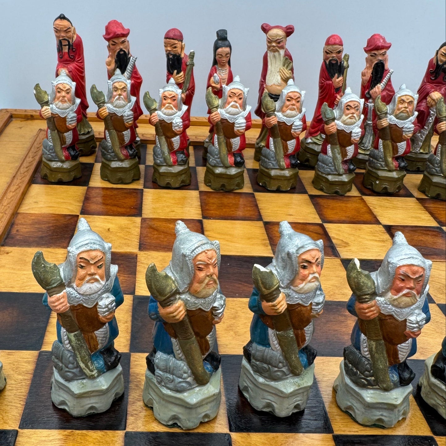 Vintage hand painted ceramic Chinese chess pieces depicting warriors and royalty.
