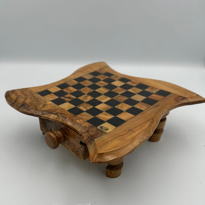 Small olive wood chess board on legs with chess pieces