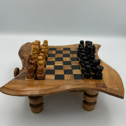 Small olive wood chess board on legs with chess pieces