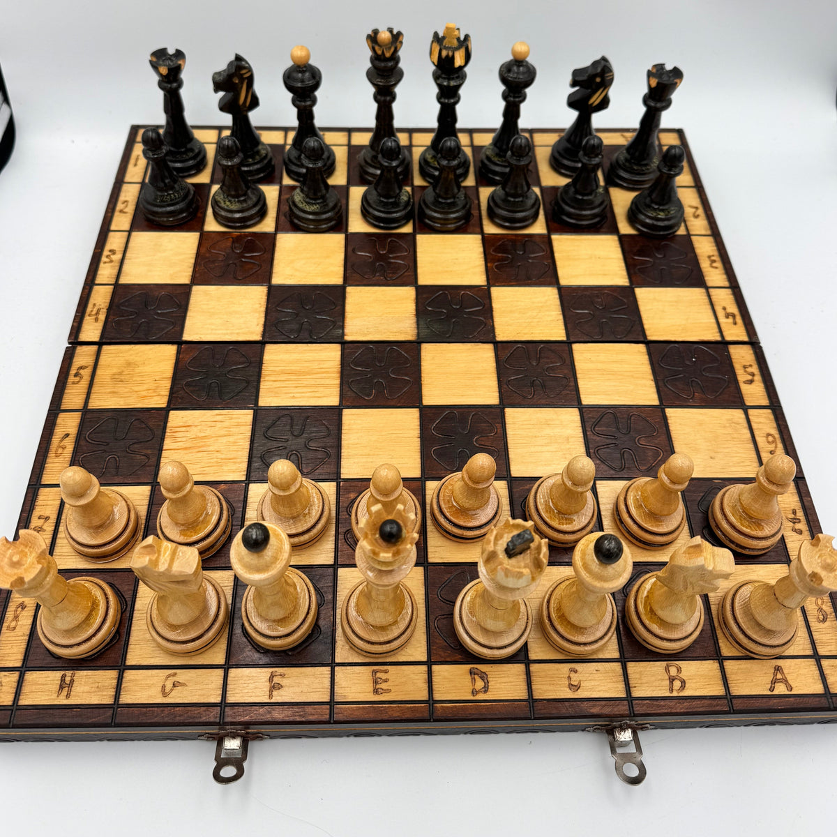 Vintage folding wooden pyrography chess board with hand carved Staunton style pieces