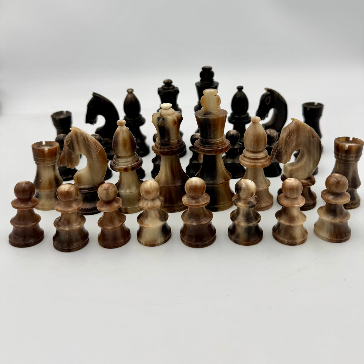 1960's library sized cow horn chess set